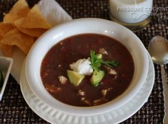 a white bowl filled with Pressure Cooker (Instant Pot) Picante Chicken and Black Bean Soup
