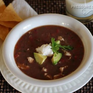 a white bowl filled with Pressure Cooker (Instant Pot) Picante Chicken and Black Bean Soup