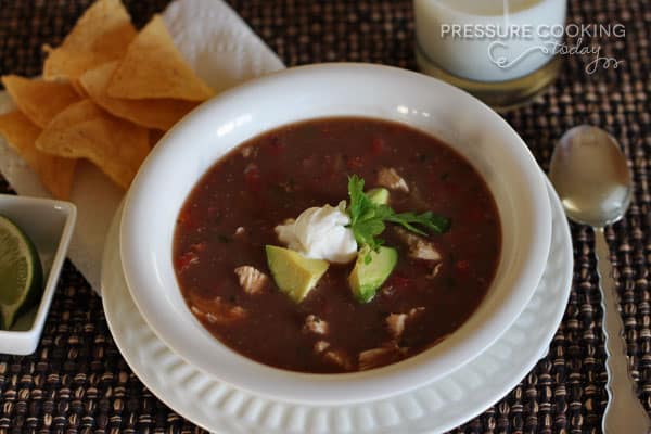 a white bowl filled with Pressure Cooker (Instant Pot) Picante Chicken and Black Bean Soup