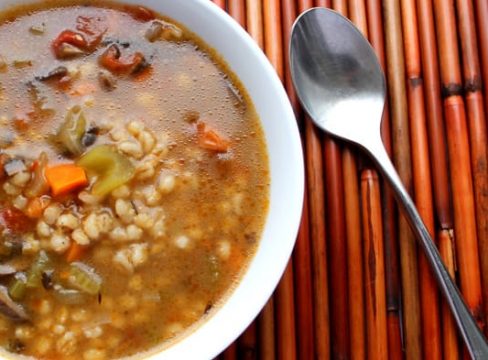 Pressure Cooker (Instant Pot) Portobello Mushroom and Barley Soup in a white bowl with a spoon beside it