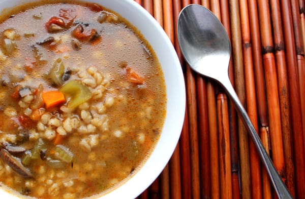 Pressure Cooker (Instant Pot) Portobello Mushroom and Barley Soup in a white bowl with a spoon beside it