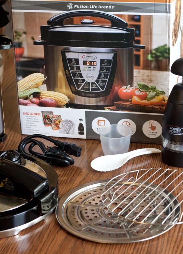 The 8 quart Power Pressure Cooker XL I bought at Costco came with a trivet, steamer tray, ladle and measure cup.