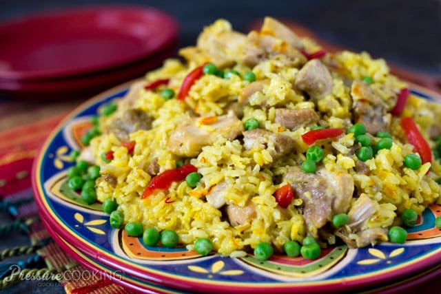 This Pressure Cooker Arroz con Pollo is a saffron braised chicken and rice dish served family style on a large platter garnished with pimiento and peas. Pressure Cooker (Instant Pot) Arroz con Pollo
