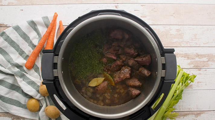 Brown the beef, beef broth, and spices in the bottom of the Instant Pot.