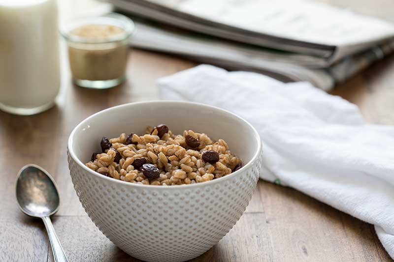 Pressure Cooker (Instant Pot) Brown Sugar Raisin Breakfast Farro served in a white bowl