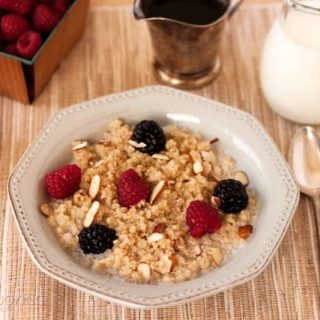 Pressure Cooker (Instant Pot) Breakfast Quinoa in a white bowl with blackberries and raspberries on the top.