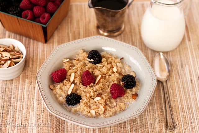 Pressure Cooker (Instant Pot) Breakfast Quinoa in a white bowl with blackberries and raspberries on the top.