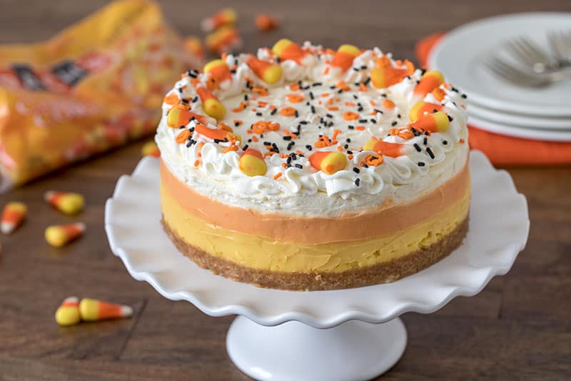 Pressure Cooker (Instant Pot) Candy Corn Cheesecake on a cake stand