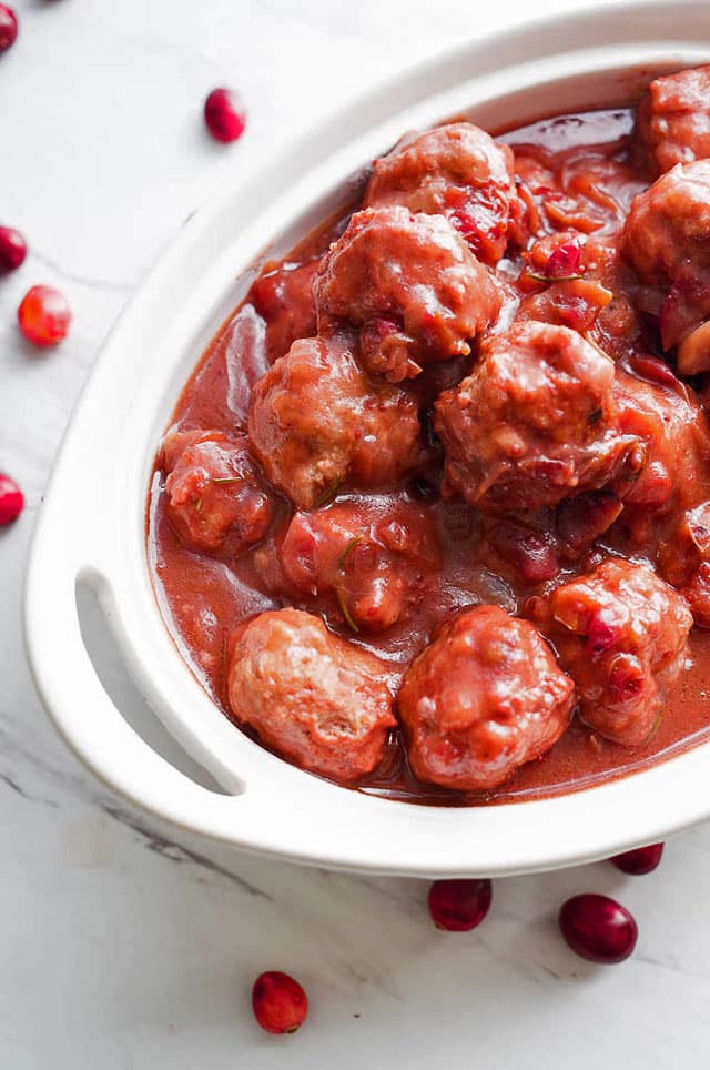 overhead photo of a white dish full of Pressure Cooker Cranberry Balsamic Meatballs