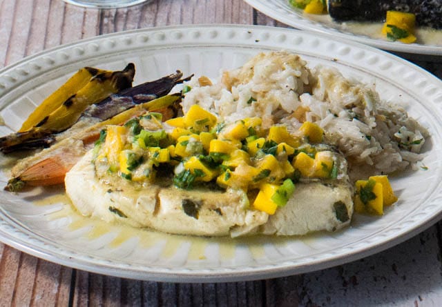 Tropical Pressure Cooker Fish In Banana Leaves (Or Parchment) served on a white plate