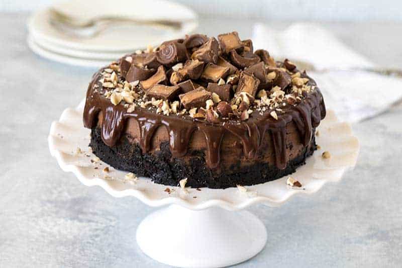 Pressure Cooker (Instant Pot) Nutella Rolo Cheesecake on a cake stand