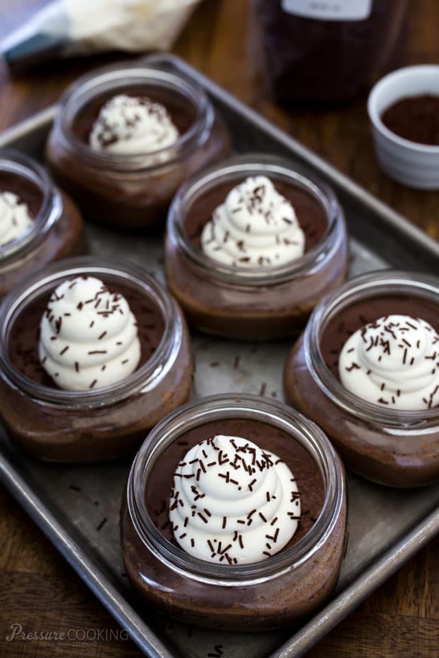 Pressure Cooked Chocolate Pots de Crème garnished with whipped cream and chocolate sprinkles