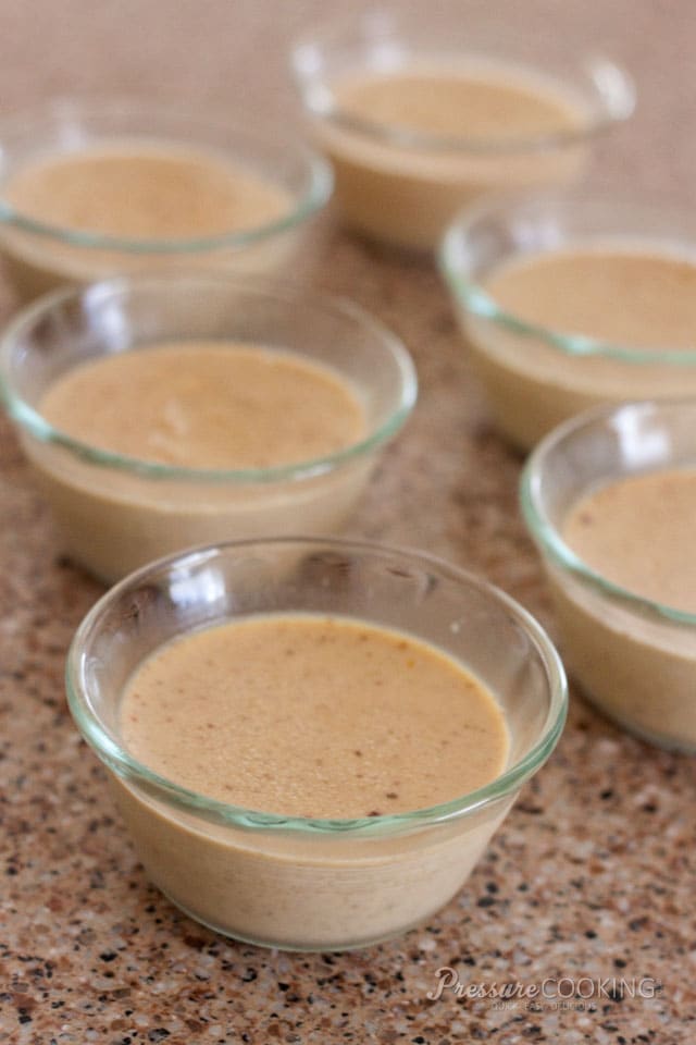 6 clear glass custard cups filled with pumpkin custard