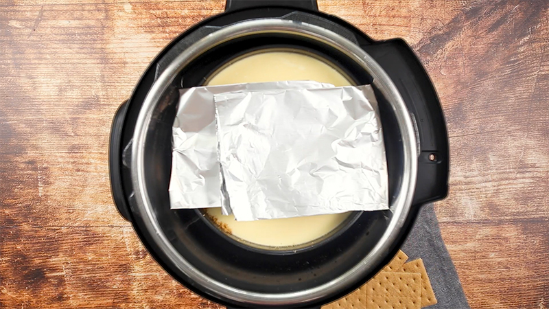Pressure Cooker Vanilla Cheesecake with a Sour Cream Topping, going into the Instant Pot uncovered for the first cook time
