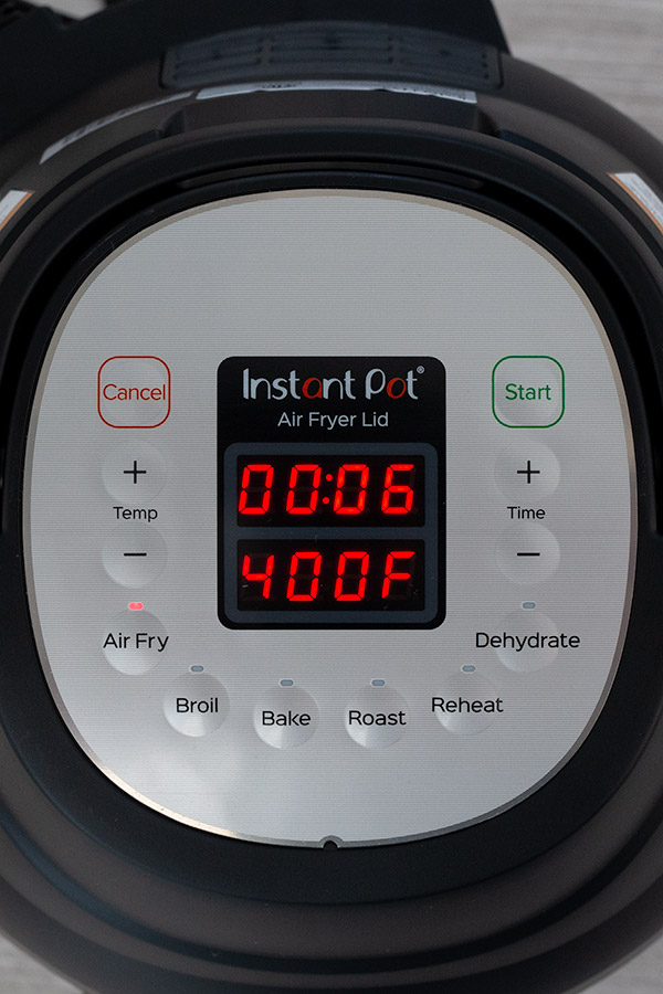 The Instant Pot Air Fryer Lid display with time and temperature.
