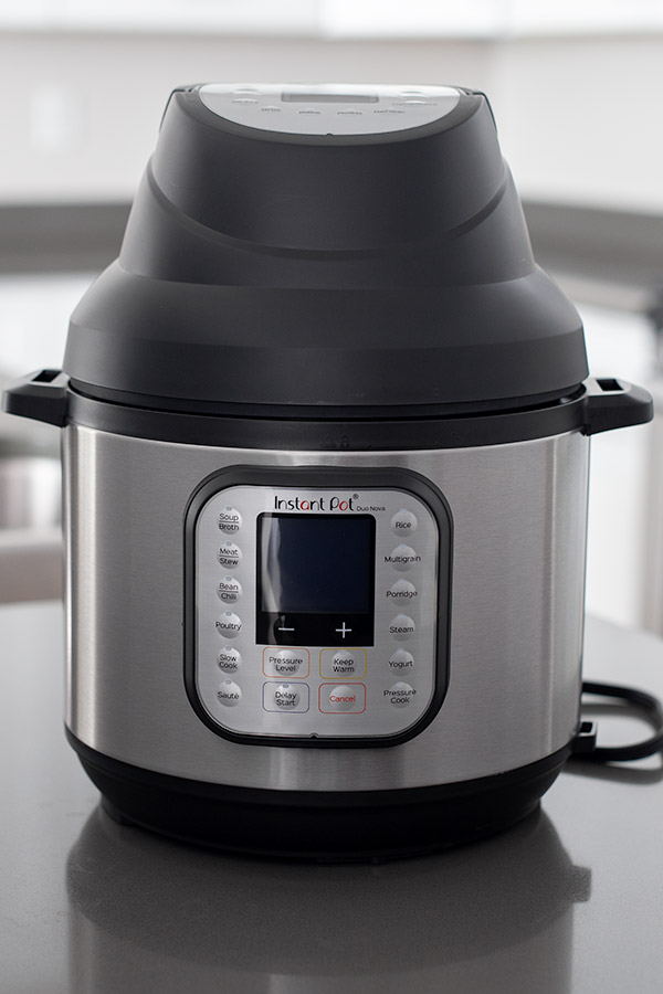 The Instant Pot Air Fryer Lid on top of an Instant Pot Nova.