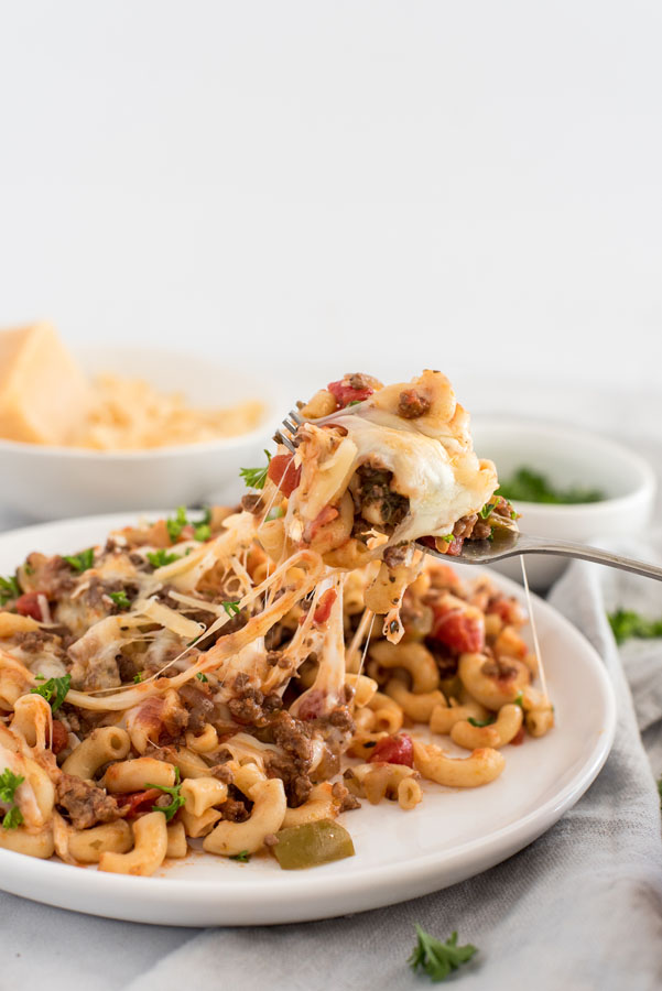 close up on a cheese pulling away from plate of Instant Pot beefaroni