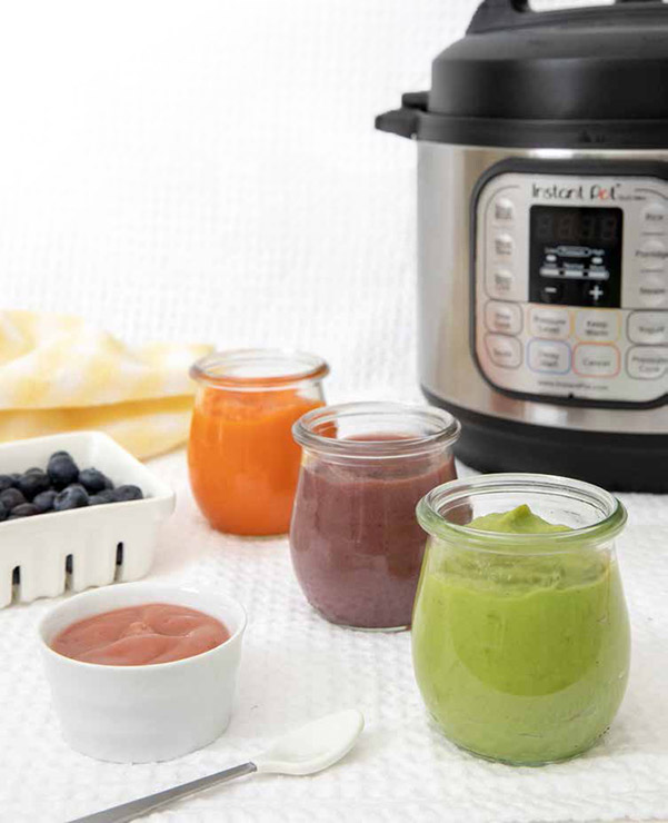 Four flavors of Baby Food Puree cooked in the Instant Pot—strawberry apple, carrot, banana blueberry pear, sweet pea and avocado purees