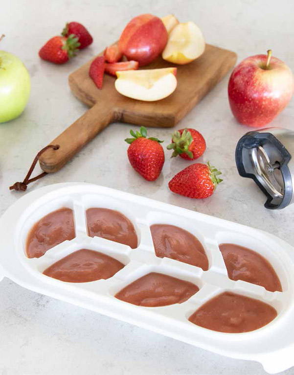 A baby food freezer container full of Strawberry Apple Pure from the InstaPot Baby Food and Toddler Food Cookbook