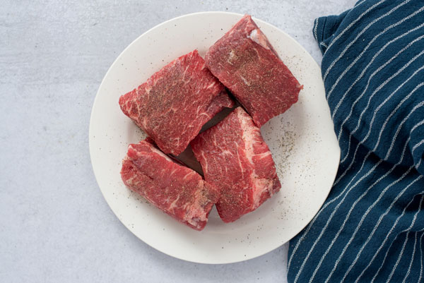 Short ribs seasoned and ready to cook in the pressure cooker.