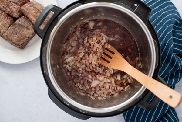 Deglazing the pot for pressure cooker short ribs.