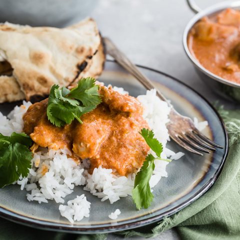 Pressure Cooker / Instant Pot Butter Chicken served on a bed of basmati rice with a side of naan