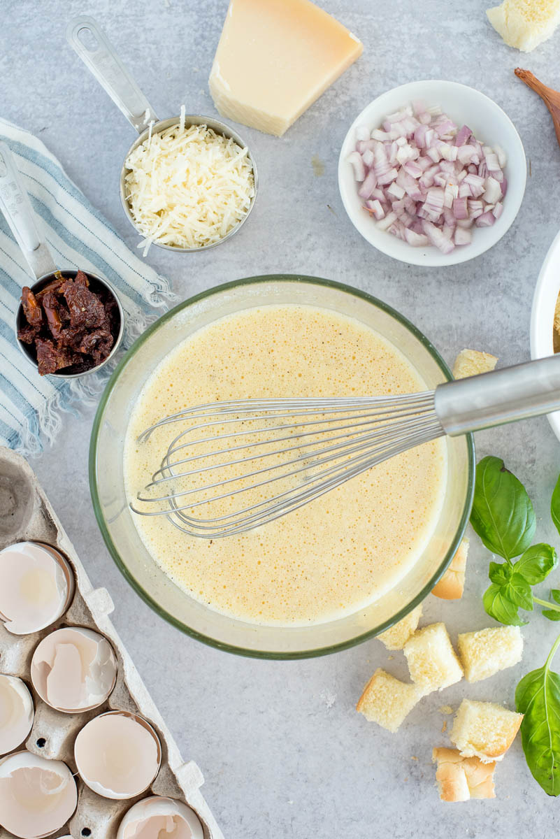 mixing bowl with the eggs for caprese breakfast casserole