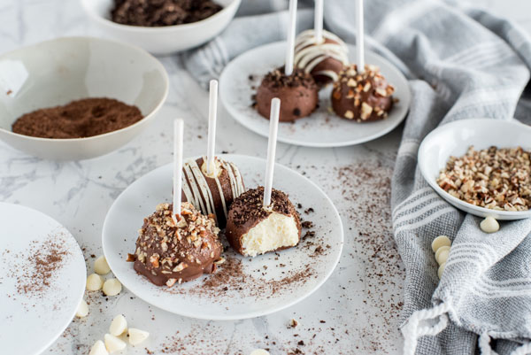 Cheesecake bites platted with a bite taken out of one to show the smooth creamy Instant Pot Cheesecake.