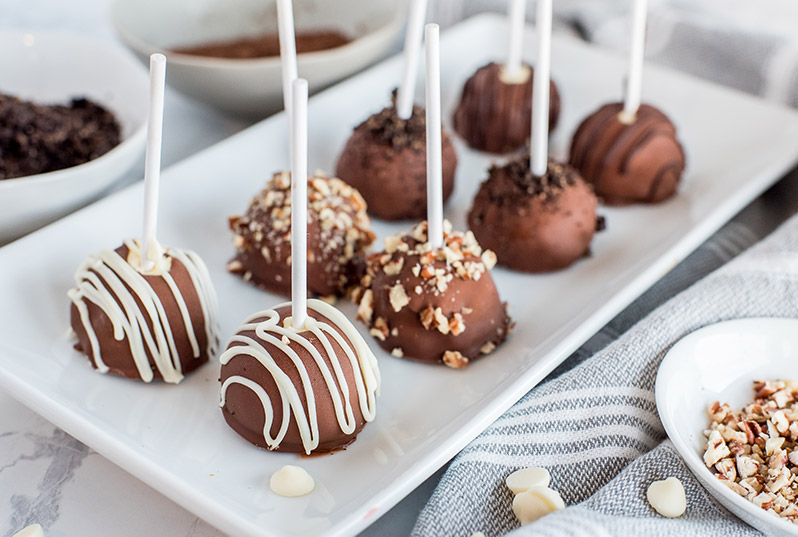 Pressure Cooker cheesecake bites / pops made in an Instant Pot and decorated with various toppings on a platter.