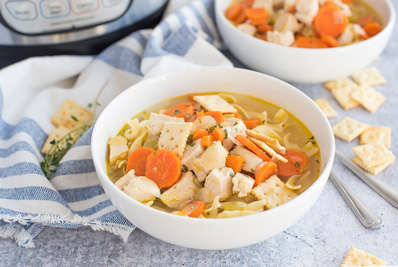 Pressure cooker chicken noodle soup made from scratch in an Instant Pot shown served in a bowl.