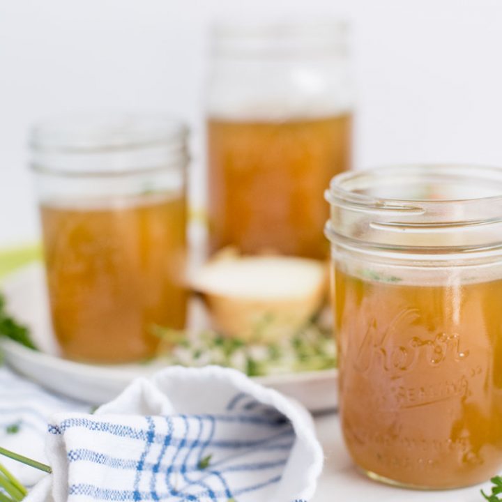 three mason jars with instant pot chicken stock