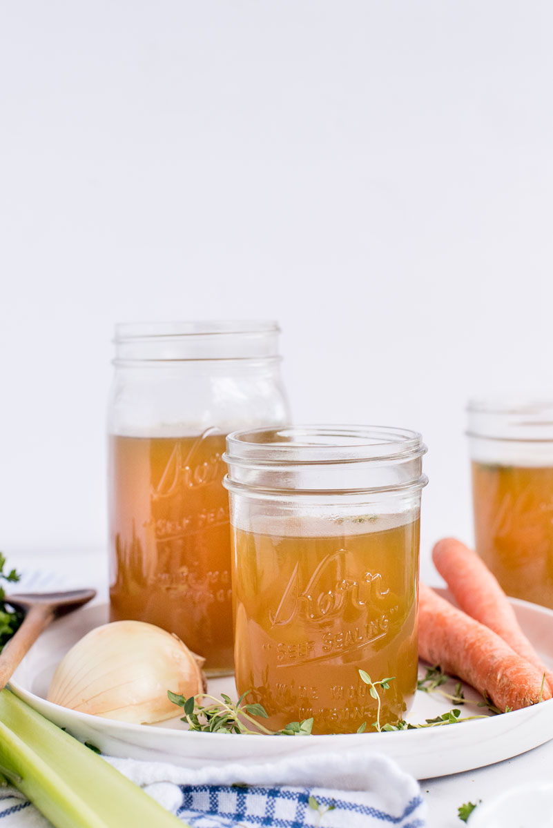 three mason jars with chicken stock