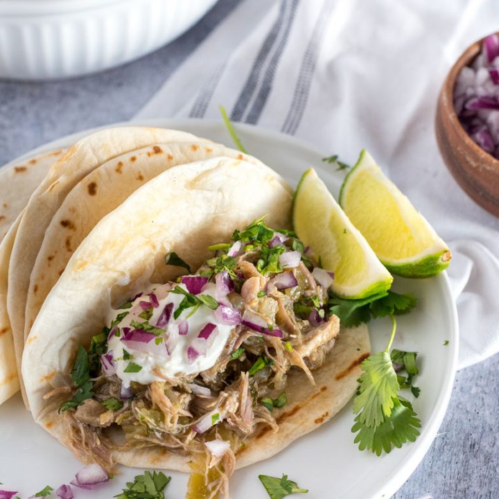 instant pot chili verde in tortillas with lime and fresh cilantro