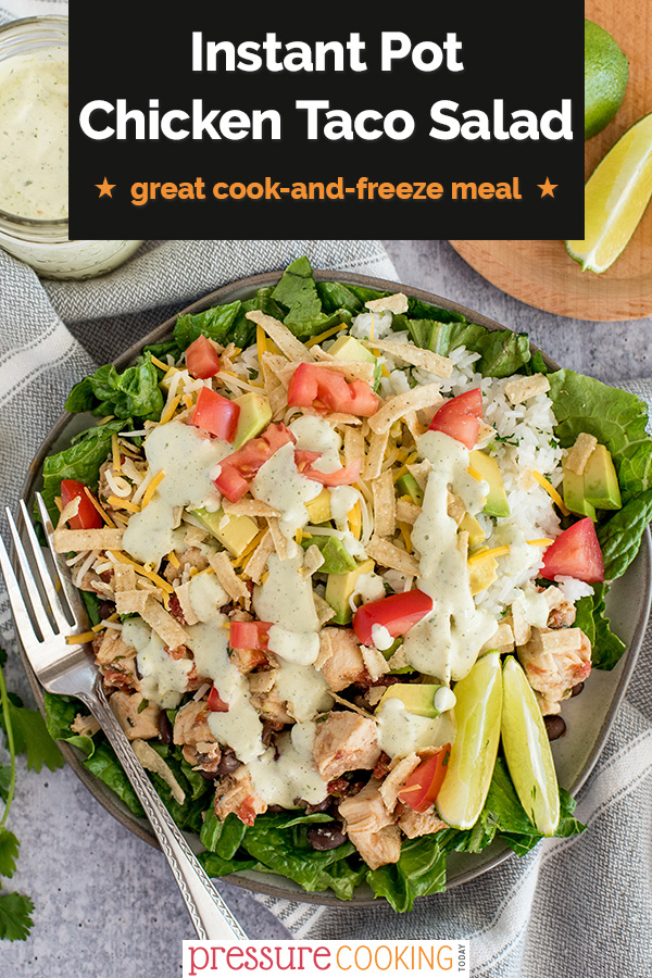 Pinterest image promoting Instant Pot chicken Taco Salad in a black text box, overlaid on a overhead shot of salad, drizzled with dressing, cheese, dicied tomatoes, lime wedges on a bed of lettuce