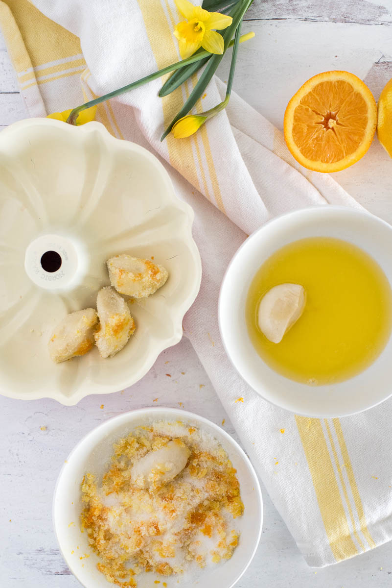 filling a bundt pan with citrus monkey bread rolls