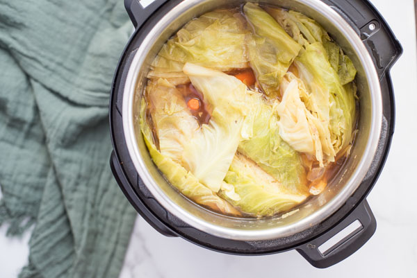 Overhead of Instant Pot filled with white cabbage before sealing to make pressure cooker corned beef and cabbage.