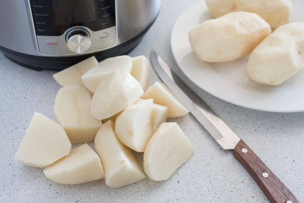 Step 1 of Instant Pot Mashed Potatoes: Quarter medium potatoes