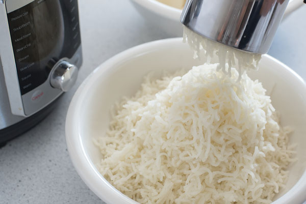 Riced potatoes next to an Instant Pot Ultra