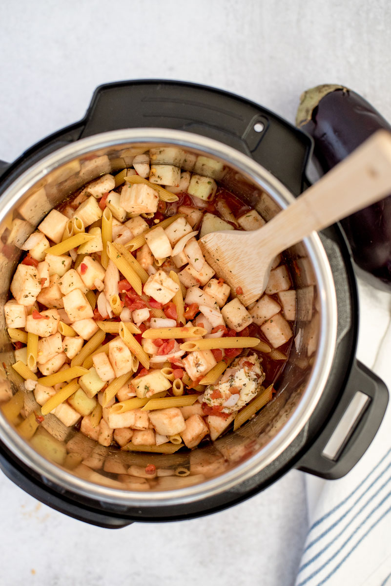 Eggplant parmigiana ingredients added to an Instant Pot and ready to cook.