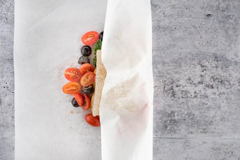 overhead of fish in parchment with the parchment folded over half