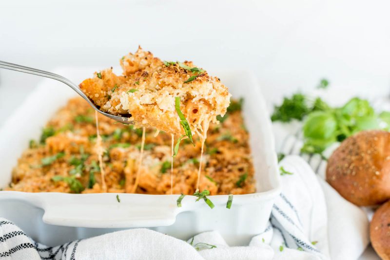 Close-up shot of a spoonful of Five Cheese Ziti, made in an Instant Pot and topped with breadcrumbs and cheese and parsley. 