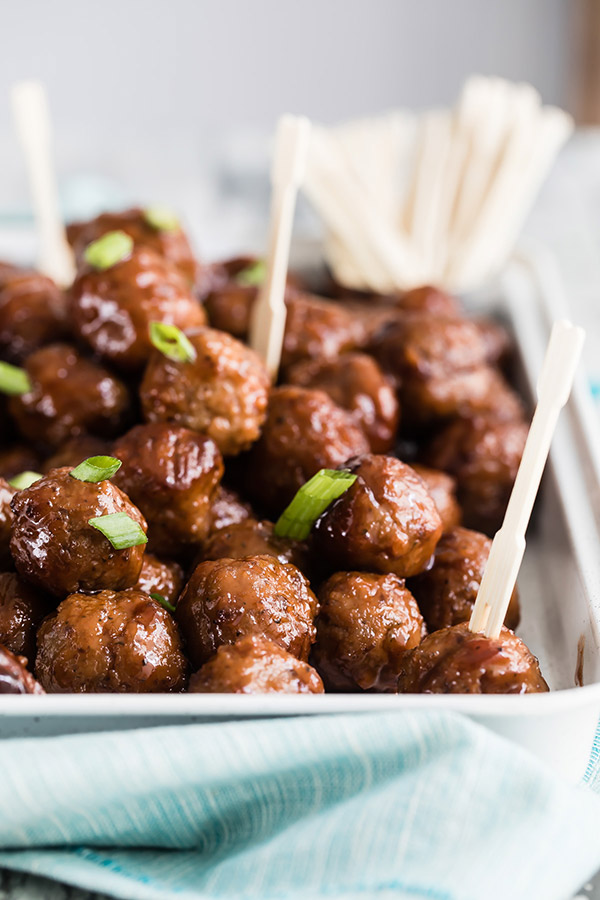 Instant Pot grape jelly meat balls on a platter with tooth picks.