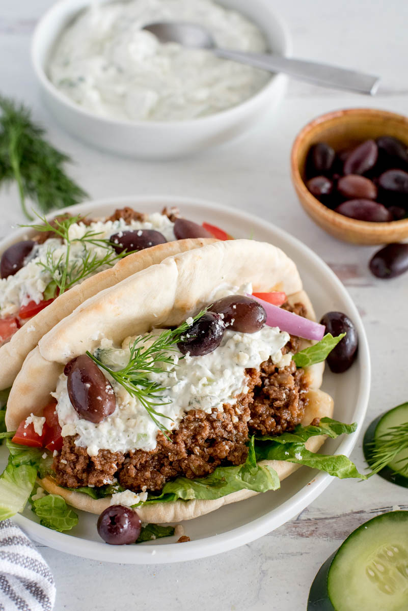 close up of pitas with greek beef tacos and yogurt sauce