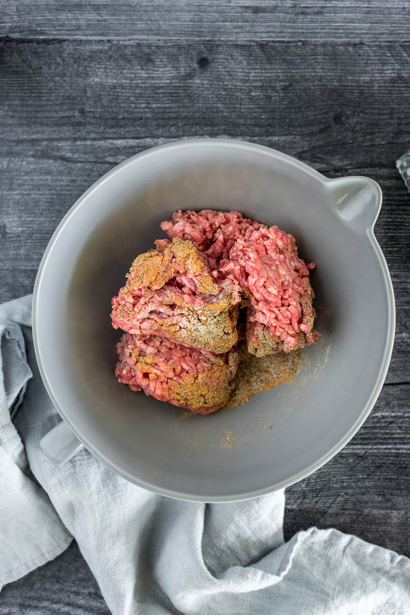 mixing bowl with hamburger meat and seasonings