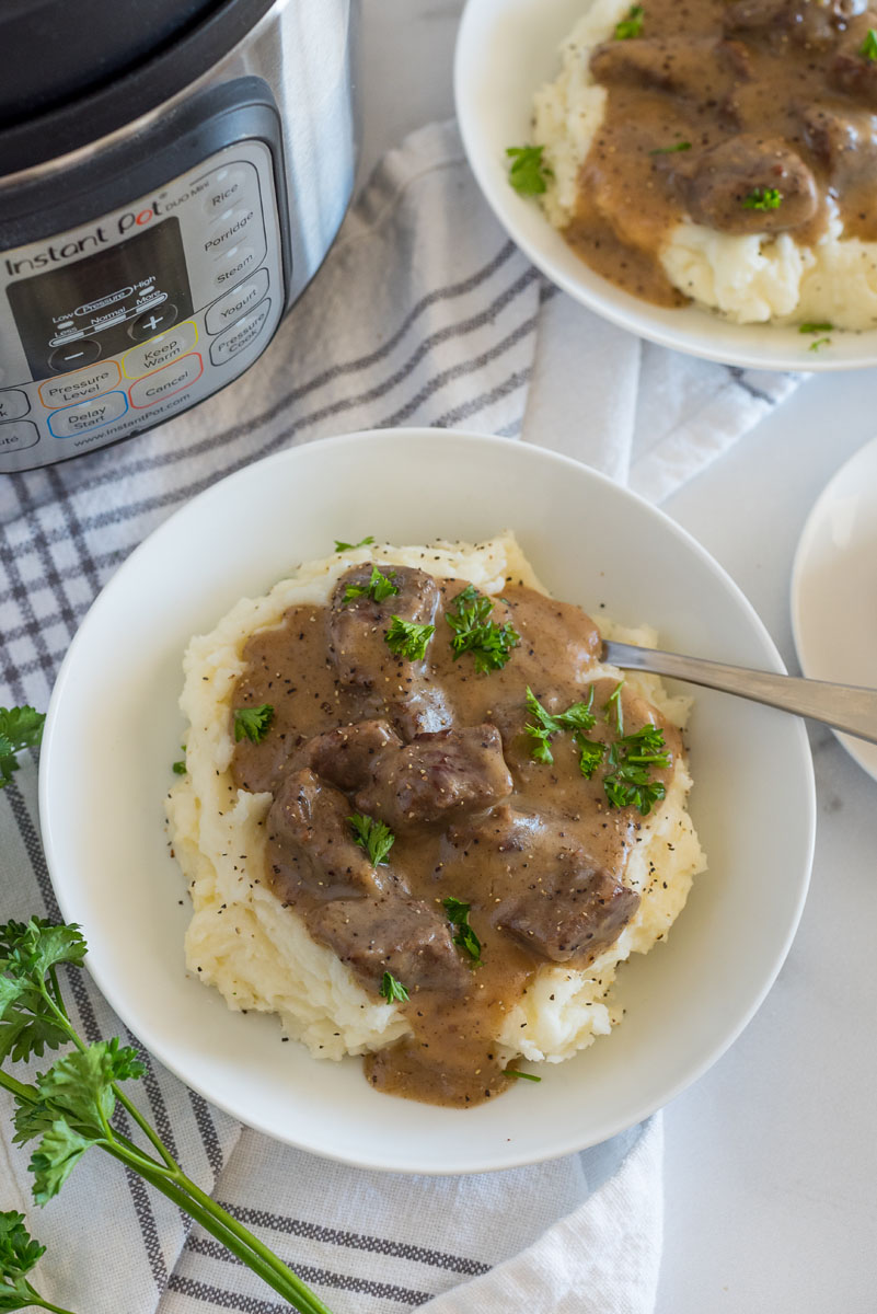 swedish kalops next to an instant pot pressure cooker