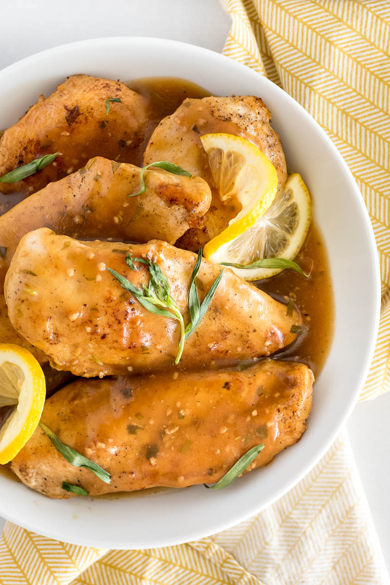 white bowl with lemon tarragon chicken breasts