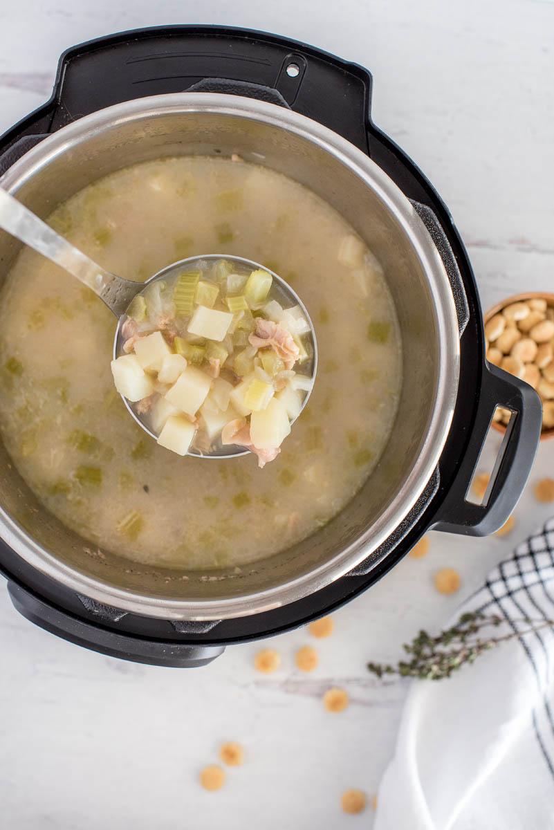 Overhead shot of light clam chowder cooked in an Instant Pot and ready to serve.