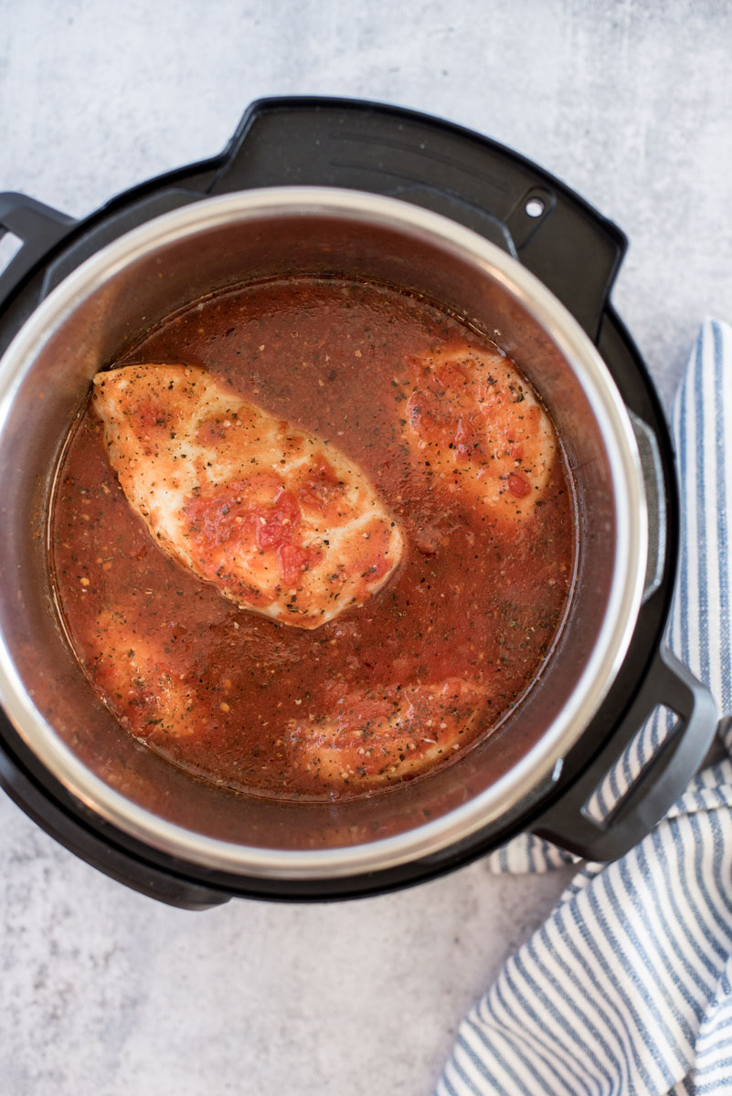 Overhead shot of chicken cooked in marinara sauce inside an Instant Pot.