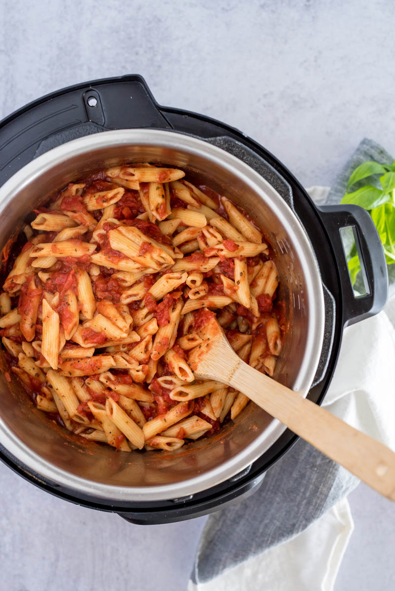 An overhead shot of the Penne and Marinara sauce mixed together after the pasta has finished cooking