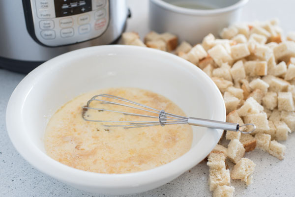 Preparing Instant Pot / Pressure Cooker Pumpkin Spice Baked French Toast with an Instant Pot in the background